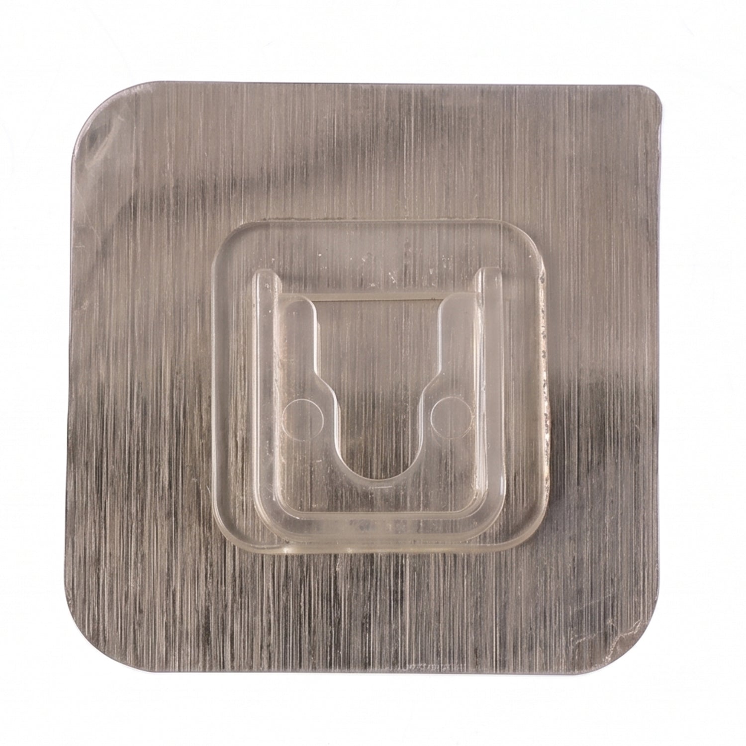Close-up of sticky transparent wall hook installation
